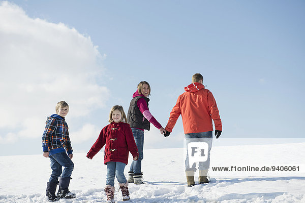 Family taking walk in winter  smiling