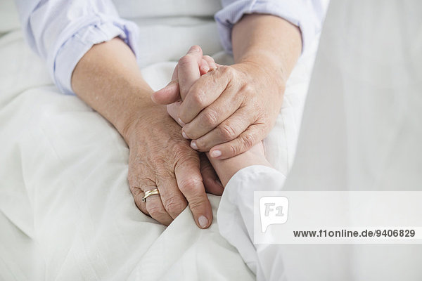 Woman holding patient's hand