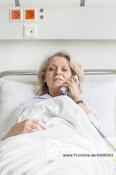 Patient in hospital phoning from bed