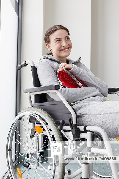 Happy woman sitting in wheelchair