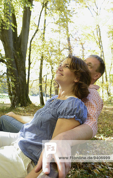 Couple sitting on bench  smiling