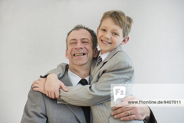 Father and son embracing each other  smiling  close up