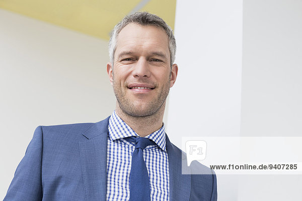 Portrait of businessman in office  smiling