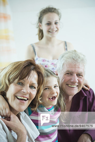 Portrait of grandparents and granddaughters  smiling