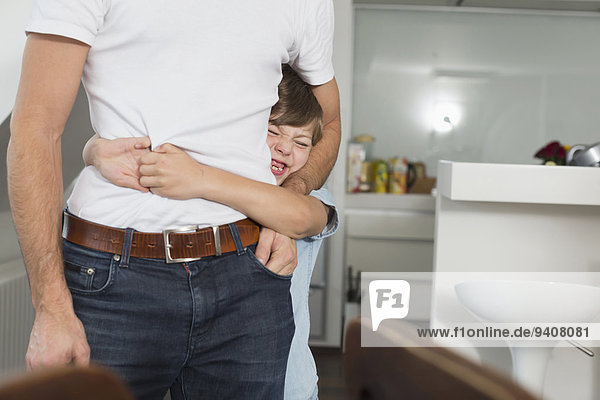 Boy hugging father