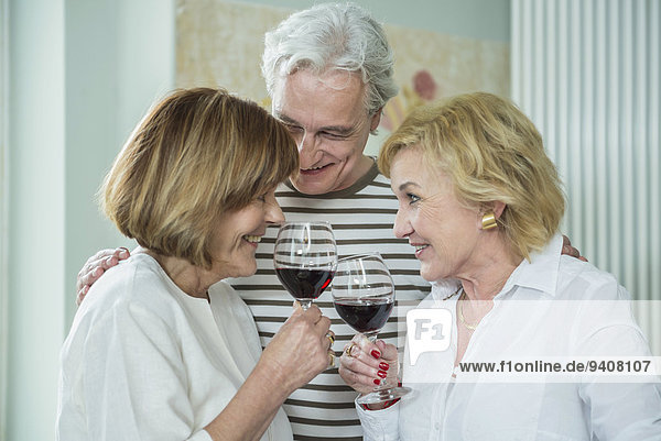Friends drinking glass of wine  smiling