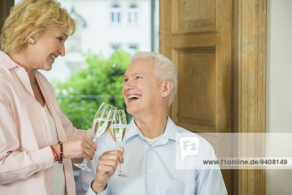 Couple clinking glasses with sparkling wine  smiling