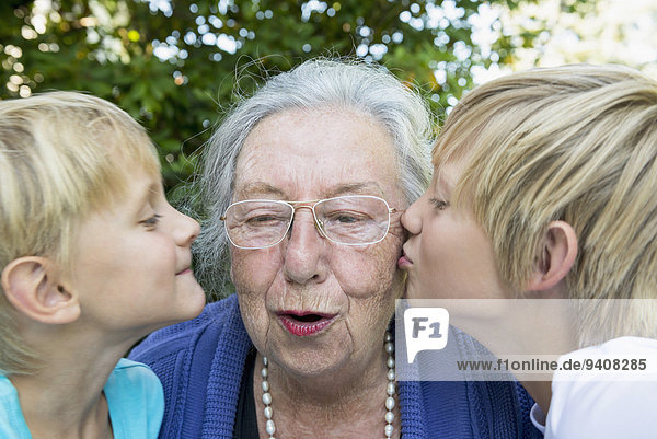 Grandsons kissing her grandmother  close-up