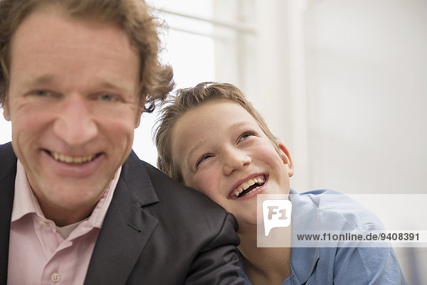 Portrait of father in suit with son