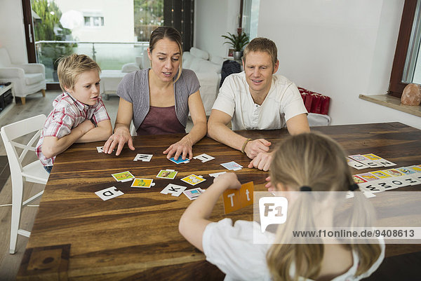 Family at living room playing parlor game together