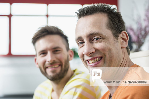 Two young men office portrait smiling meeting