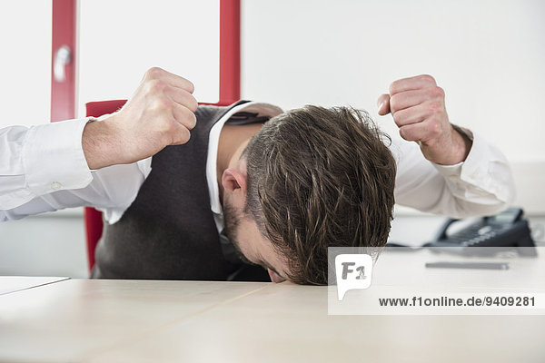 Man office stress problem fist hitting desk