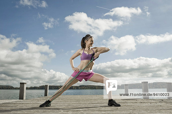 Woman woman exercising with resistance band  Woerthsee