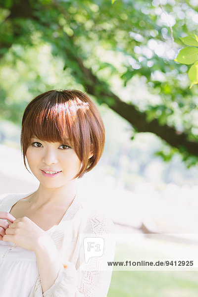 Portrait of young Japanese woman in a park