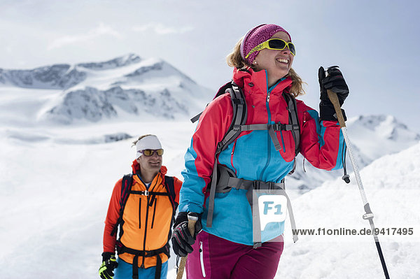 Portrait couple cross-country skiing Alps