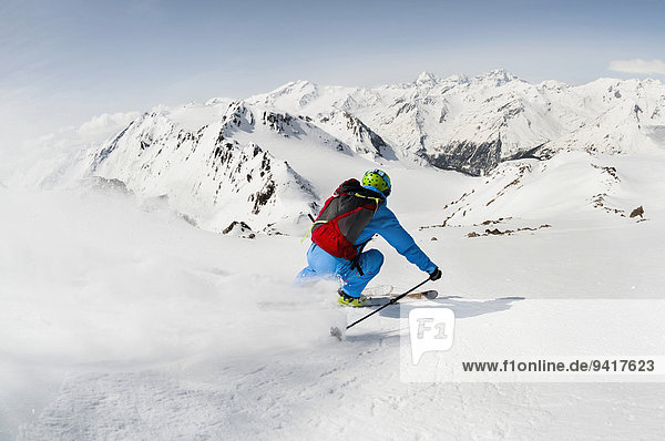 Man skier skiing downhill steep slope mountains