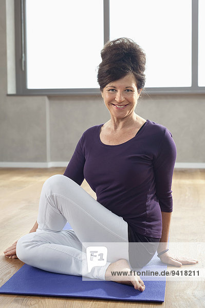 Mature woman portrait fit wellness yoga position
