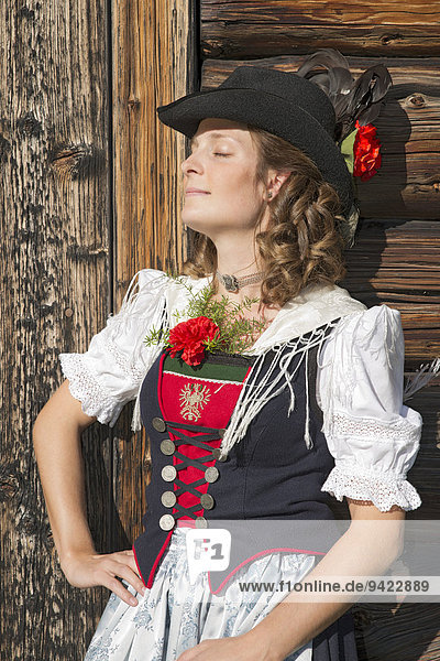 Young woman in traditional costume  typical for the region Achensee Tyrolean traditional costume  Achenkirch  Tyrol  Austria