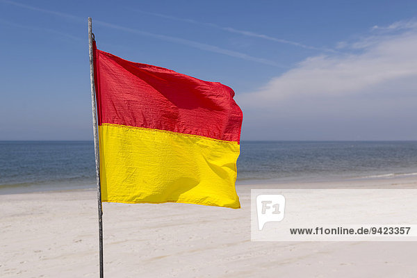 A red-yellow flag waves on the beach  near Kampen  Sylt  Schleswig-Holstein  Germany