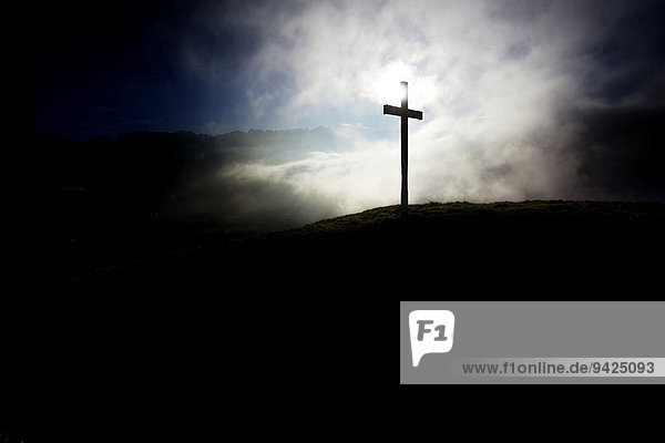 Summit cross of Gerenberg Mountain with high fog in front of the Alpstein Mountains  Gerenberg  Appenzell  Switzerland