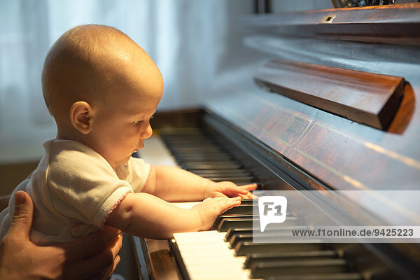 Baby  4-5 months old  at a piano  Germany