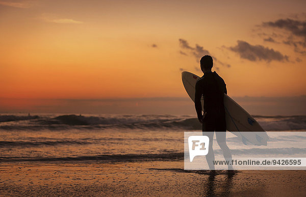 Surfer at sunset  Sanur Beach  Bali  Indonesia