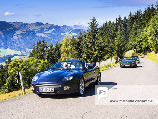 Aston Martin DB7 Vantage Volange cars on a mountain road near Kitzbühel  Tyrol  Austria