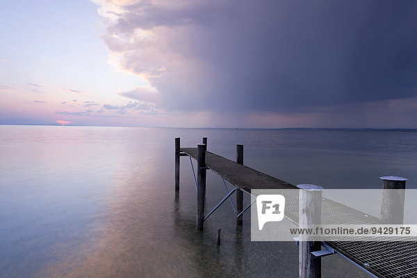 Jetty with evening light and stormy atmosphere overlooking Lake Constance near Bregenz  Rohrspitz  Austria  Europe