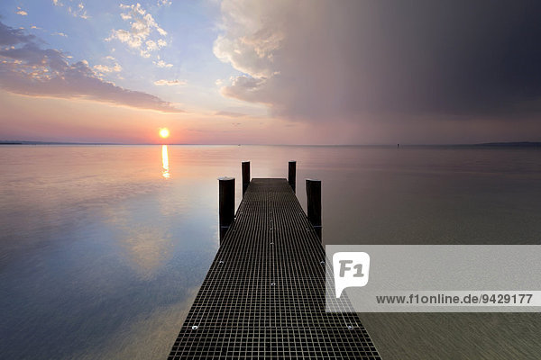 Jetty with evening light and stormy atmosphere overlooking Lake Constance near Bregenz  Rohrspitz  Austria  Europe