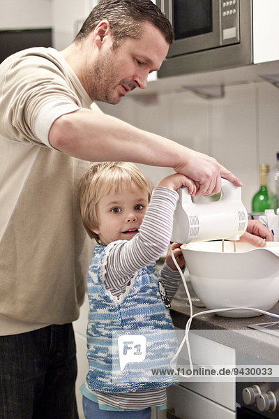 Father and daughter in kitchen  Kiel  Schleswig-Holstein  Germany  Europe