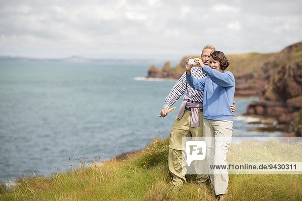 Couple taking selfie  Coast Path near Marloes  Pembrokeshire Coast National Park  Wales  UK