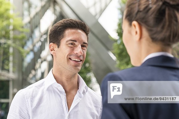 Young businessman and woman chatting at Broadgate Tower  London  UK