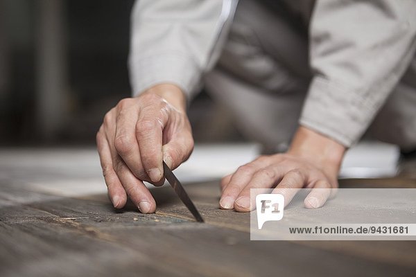 Carpenter checking quality of wood plank in factory  Jiangsu  China