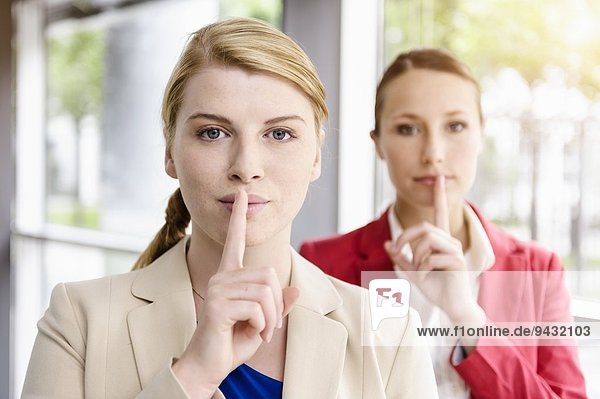 Businesswomen sharing secret