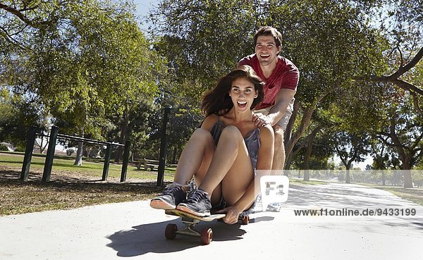 Junges Paar Skateboarden im Park