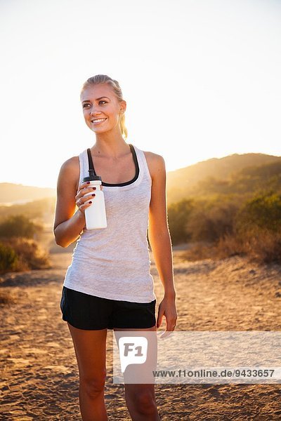 Young female jogger holding water bottle  Poway  CA  USA