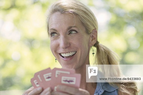 Reife Frau beim Kartenspielen