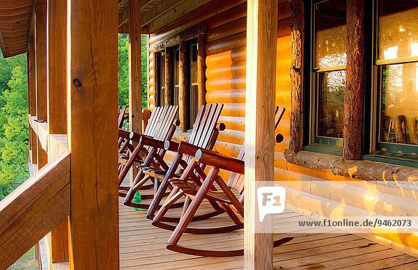 Wooden Cabin With Rocking Chairs On Wrap Around Porch In Copperhill Tennessee Usa