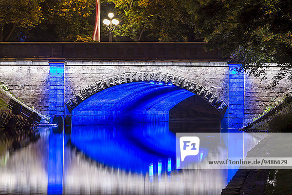 Illuminated bridge along the Pilsetas Canal  Riga  Latvia  Europe