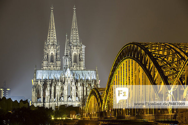 The illuminated Cologne Cathedral and Hohenzollern Bridge at night  Deutz  Cologne  North Rhine-Westphalia  Germany  Europe