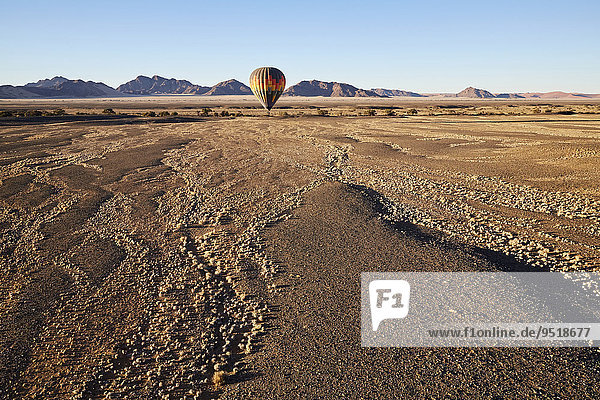Hot air balloon  behind the Naukluft Mountains  Namib-Naukluft National Park  Namib Desert  Namibia  Africa