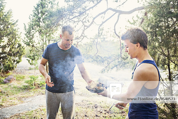 Father with son having barbecue