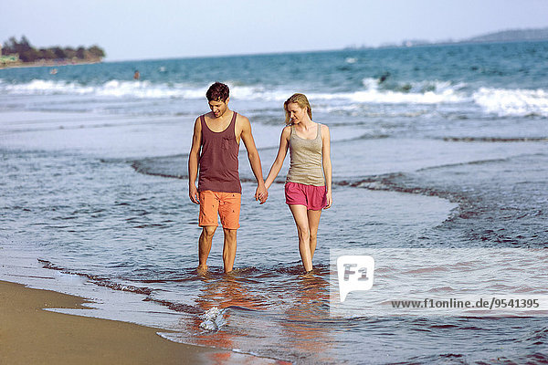 Young couple walking on beach