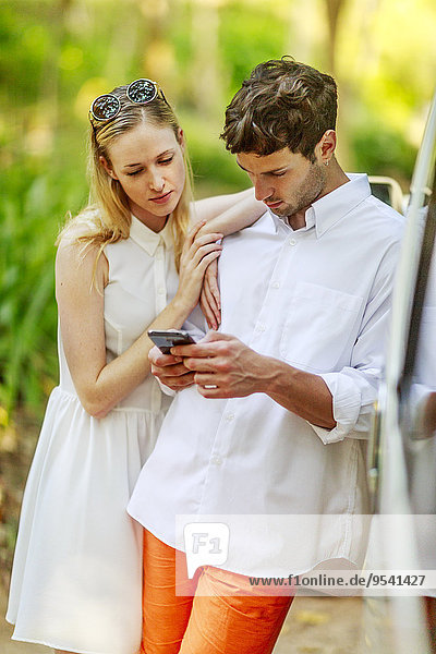 Young couple looking at cell phone