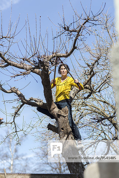 Woman cutting tree branches