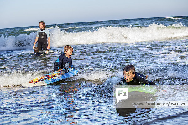 Mother with sons surfing