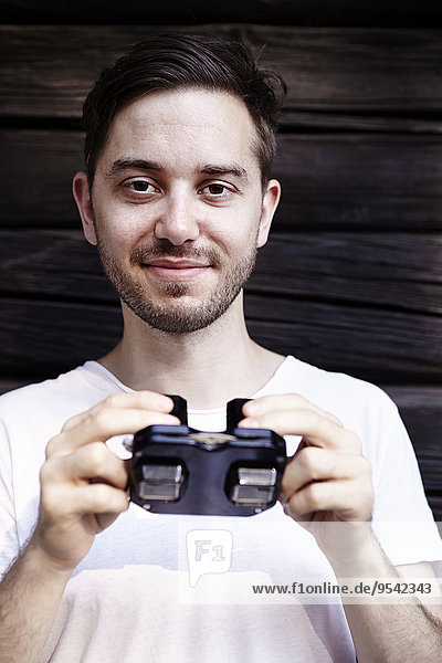Portrait of man holding viewfinder