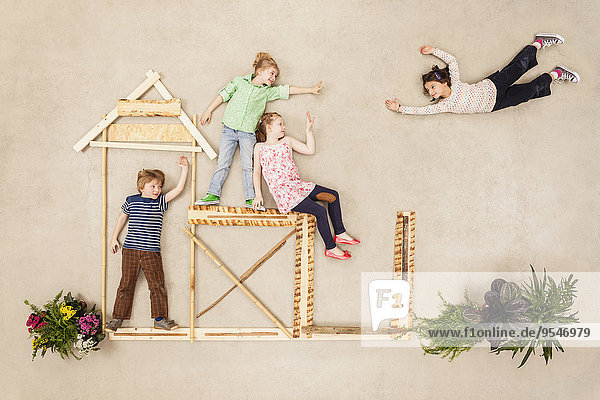 Kids playing outdoor  building wooden hut