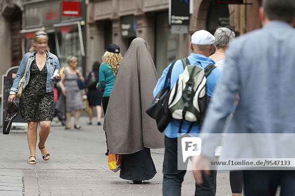 Strasbourg (Alsace region): A veiled woman (wearing hijab) is walking in the city streets. June  2013