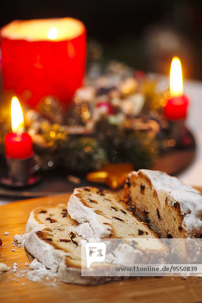 Sliced Stollen and lighted candles at Advent season